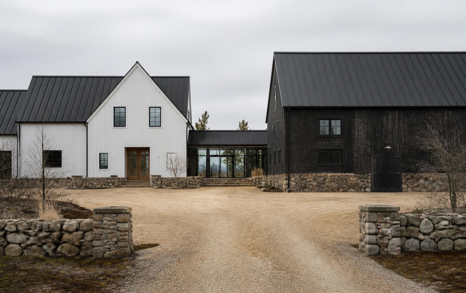 Concept visualization of the entry elevation of a farmstead compound with a white board-and-batten house, glazed link and dark timber barn on fieldstone bases