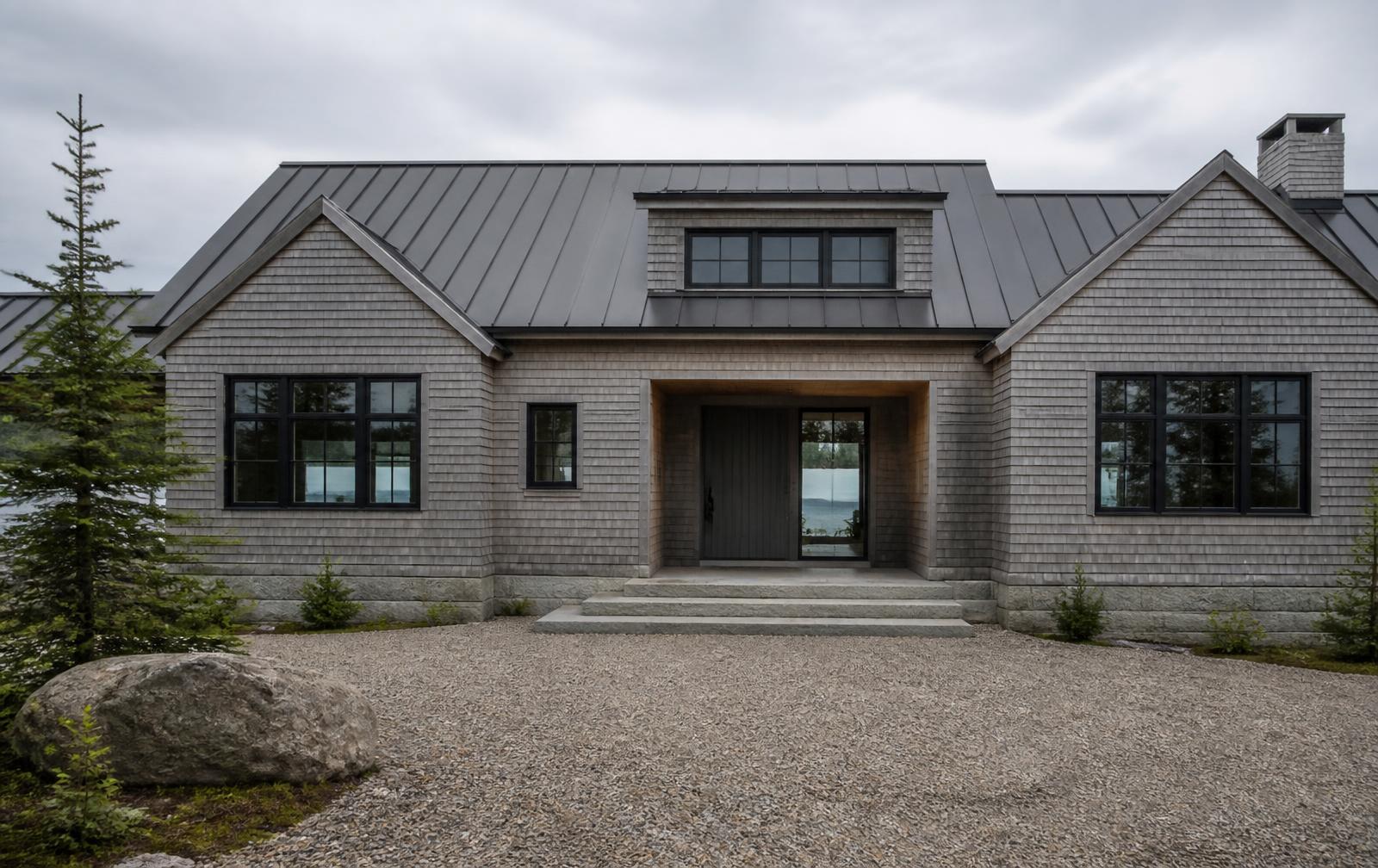 Concept visualization of the entry elevation of a coastal Maine residence in weathered cedar shingle with a recessed sheltered entry and granite steps