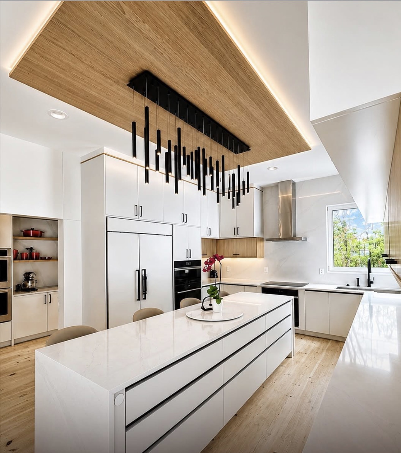 Bedford Residence kitchen — waterfall island, white oak ceiling raft and linear pendant array