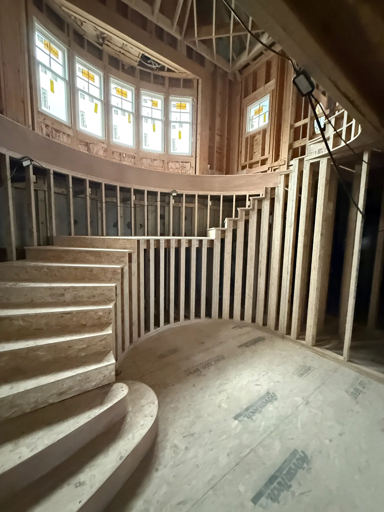 Curved stair structure taking shape during rough carpentry
