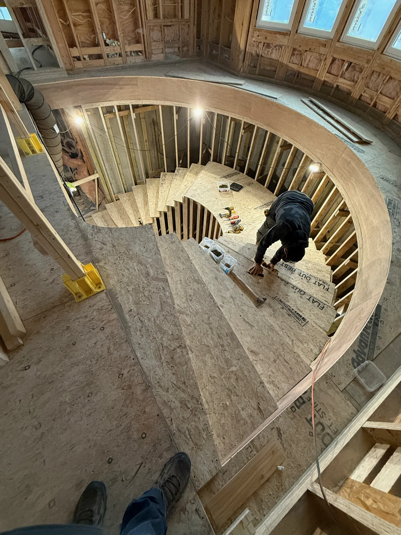 Carpenter working on a curved stair during construction