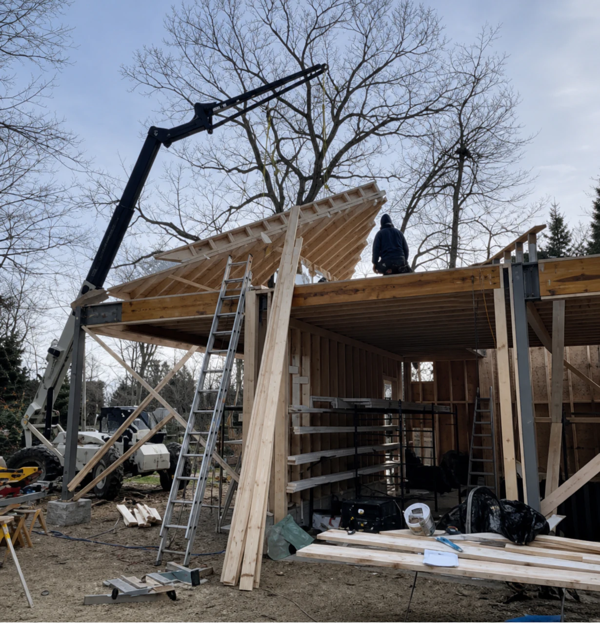 Conventional wood roof framing being lifted into place by the field crew