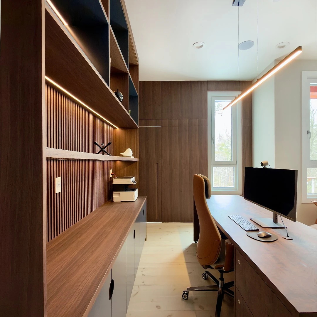 Office millwork run at the Bedford Residence showing walnut shelving, integrated lighting and resolved panel joints