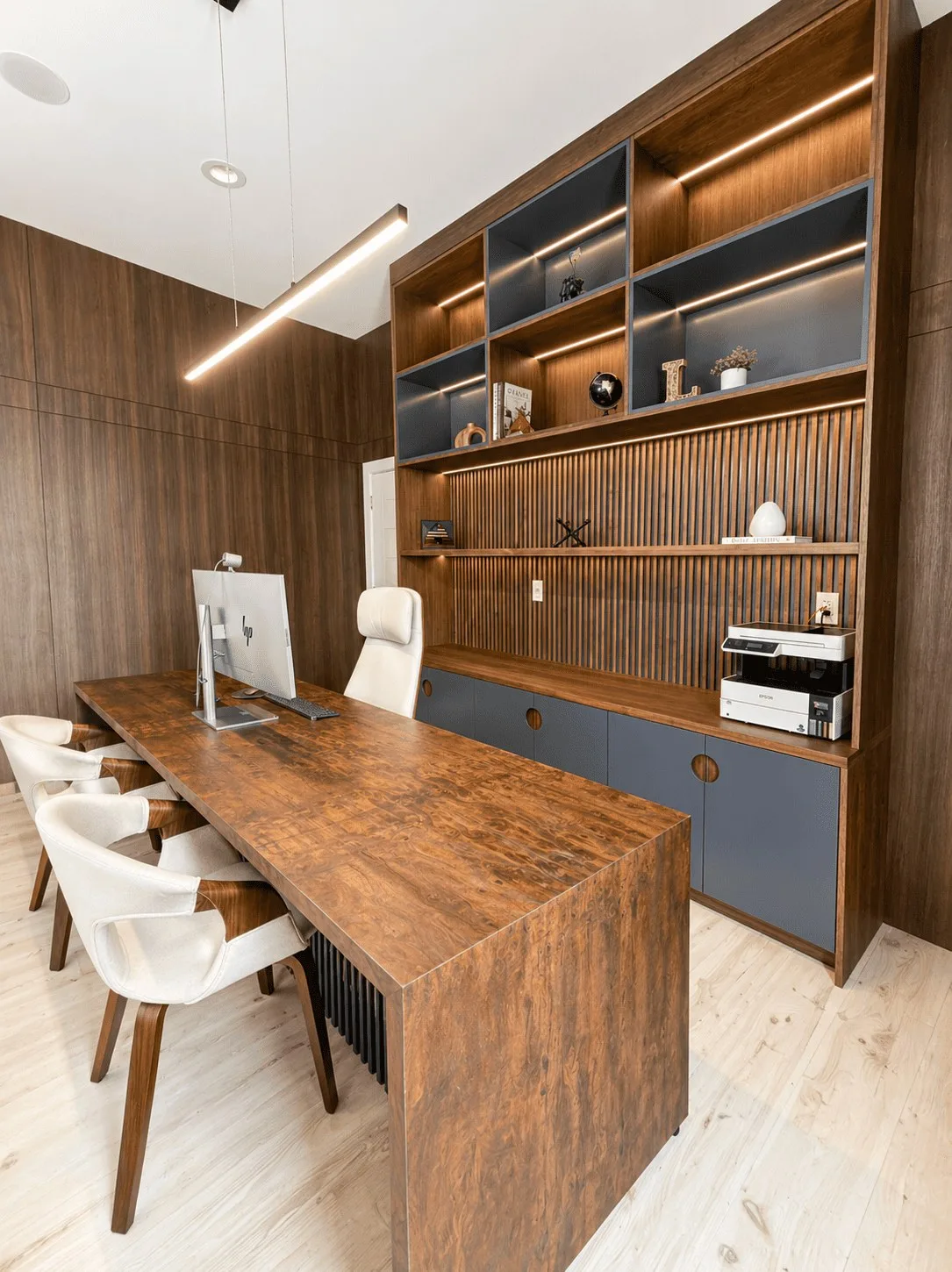 Bedford Residence walnut office with lit shelving and a live-edge desk