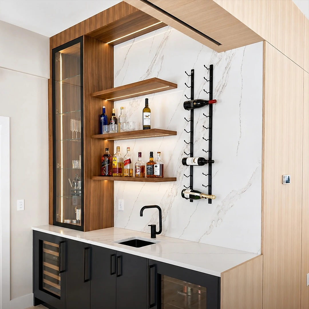 Wet bar at the Bedford Residence with a marble slab surround, walnut shelving, glass display cabinet and undercounter refrigeration